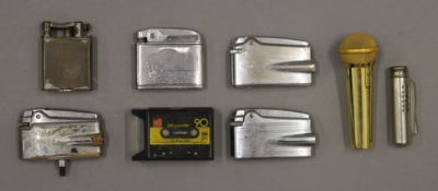 A collection of vintage lighters and match boxes, etc.