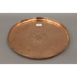 A Hugh Wallis Arts and Crafts copper charger. 38 cm diameter.