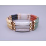 A 14 ct gold multi-colour jade bracelet. 18 cm long.