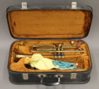 A Corton brass trumpet, cased.