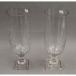 A pair of hurricane lamps. 34 cm high.