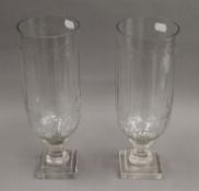 A pair of hurricane lamps. 34 cm high.