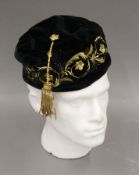 A black Lock & Co of St James's Street velvet and quilt lined embroidered smoking cap.