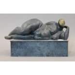 An abstract patinated bronze sculpture of a reclining nude. 25 cm long.