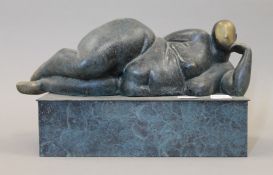 An abstract patinated bronze sculpture of a reclining nude. 25 cm long.