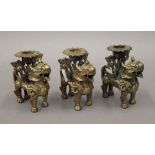 Three Chinese bronze dog-of-fo form candlesticks. 9 cm high.