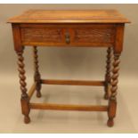A Victorian carved oak single drawer barley twist side table. 67.5 cm wide.