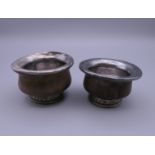 A pair of Tibetan unmarked white metal and wood mazer bowls. 6.5 cm diameter.