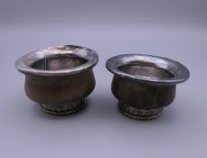 A pair of Tibetan unmarked white metal and wood mazer bowls. 6.5 cm diameter.
