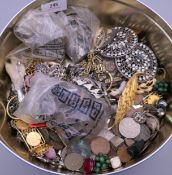 A tin of various costume jewellery.