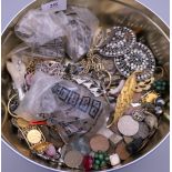 A tin of various costume jewellery.