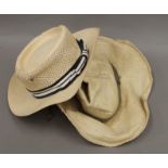 Two Panama straw hats, one by Adam, the other by Borsolino. Sizes 7 1/8 and 7 1/2.