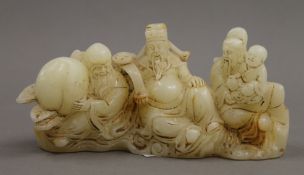 A Chinese carved jade figural brush rest. 16 cm wide.