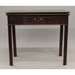 A George III mahogany fold over tea table. 83.5 cm wide.