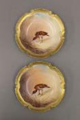 A pair of Limoges dishes, each painted with a bird. 15 cm diameter.