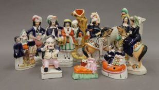 A collection of various Staffordshire figures.