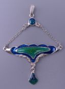 An Art Nouveau style silver pendant. 5 cm high.