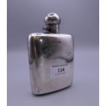 A silver hip flask. 12.5 cm high. 134.6 grammes.