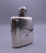 A silver hip flask. 12.5 cm high. 134.6 grammes.