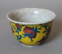 A Chinese yellow ground porcelain tea bowl. 9 cm diameter.