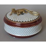 A porcelain box mounted with a lizard. 14 cm diameter.