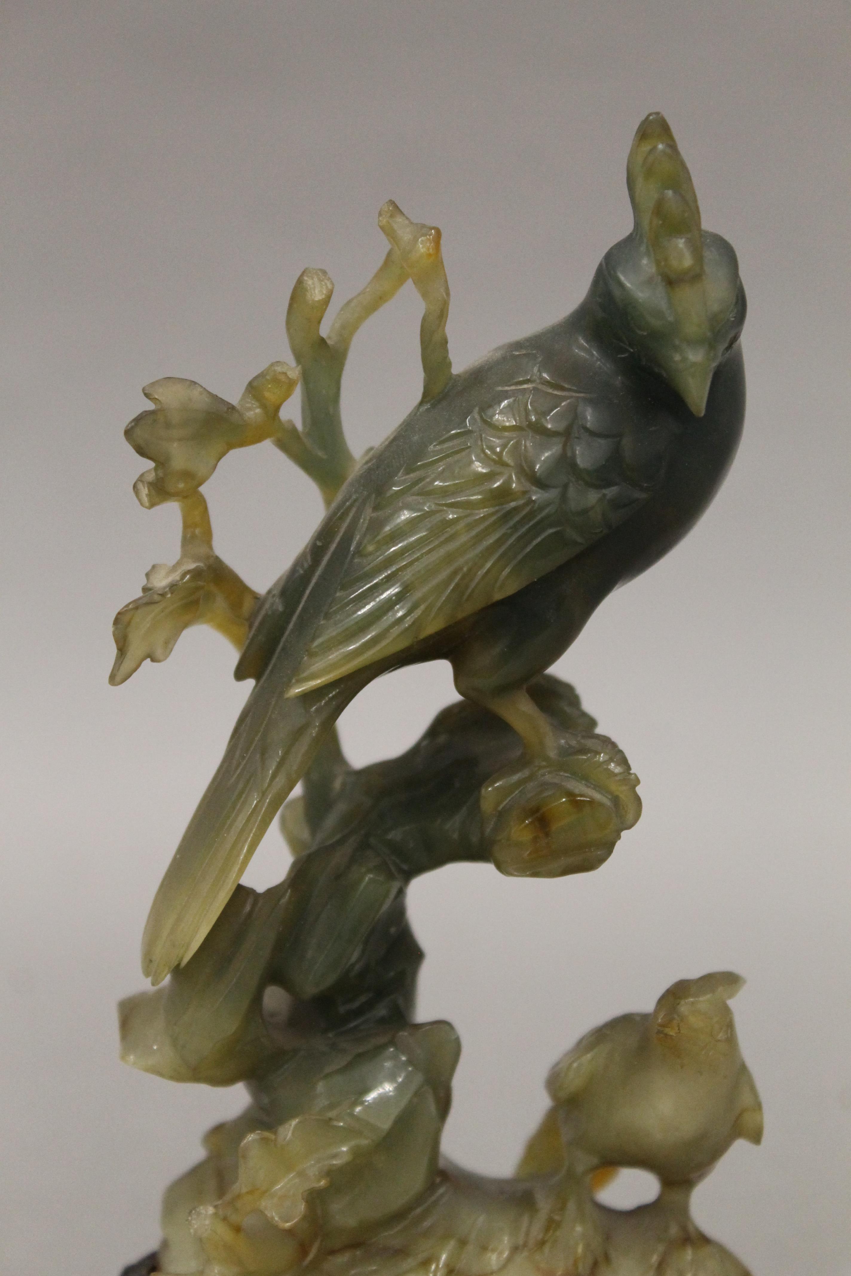 A Chinese carved jade model of birds mounted on a carved wooden stand. 15 cm high overall. - Image 2 of 3