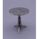 A Chinese miniature silver table. 4.5 cm high. 30.3 grammes.