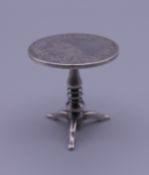 A Chinese miniature silver table. 4.5 cm high. 30.3 grammes.