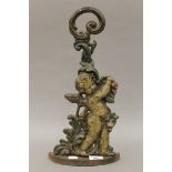 A Victorian cast iron door stop formed as a cherub. 41 cm high.