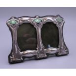 An Art Nouveau style silver double photograph frame. 11 cm wide.