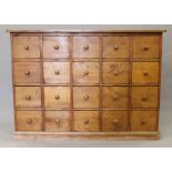 A pine bank of twenty drawers. 137 cm wide.