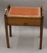 An Edwardian mahogany piano stool. 49 cm wide.