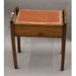 An Edwardian mahogany piano stool. 49 cm wide.