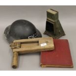 A First Aid book, together with a lamp, rattle and a First Aid Ekco helmet.