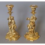 A pair of gilt bronze figural candlesticks. Each 28 cm high.