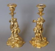 A pair of gilt bronze figural candlesticks. Each 28 cm high.