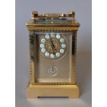 A gilt bronze repeating carriage clock. 19 cm high.