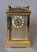 A gilt bronze repeating carriage clock. 19 cm high.