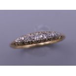 An 18 ct gold five stone diamond ring. Ring size Q/R. 3.3 grammes total weight.