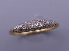 An 18 ct gold five stone diamond ring. Ring size Q/R. 3.3 grammes total weight.