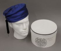 A blue Lock & Co of St James's Street, silk and quilt lined smoking cap, in its makers box.