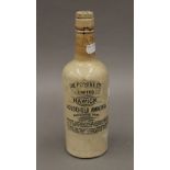 A Victorian stoneware household ammonia bottle. 27 cm high.