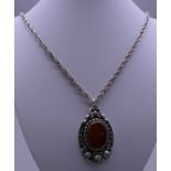 A German silver pendant set with agate, on chain. The pendant 5 cm high.