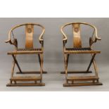 A pair of late 19th/early 20th century Chinese brass mounted carved elm folding open armchairs.