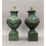 A pair of green painted table lamps. Each approximately 55 cm high.
