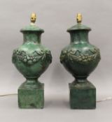 A pair of green painted table lamps. Each approximately 55 cm high.