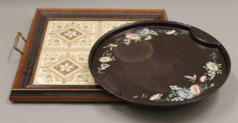 Two small trays, one set with tiles. The largest 42 cm wide.