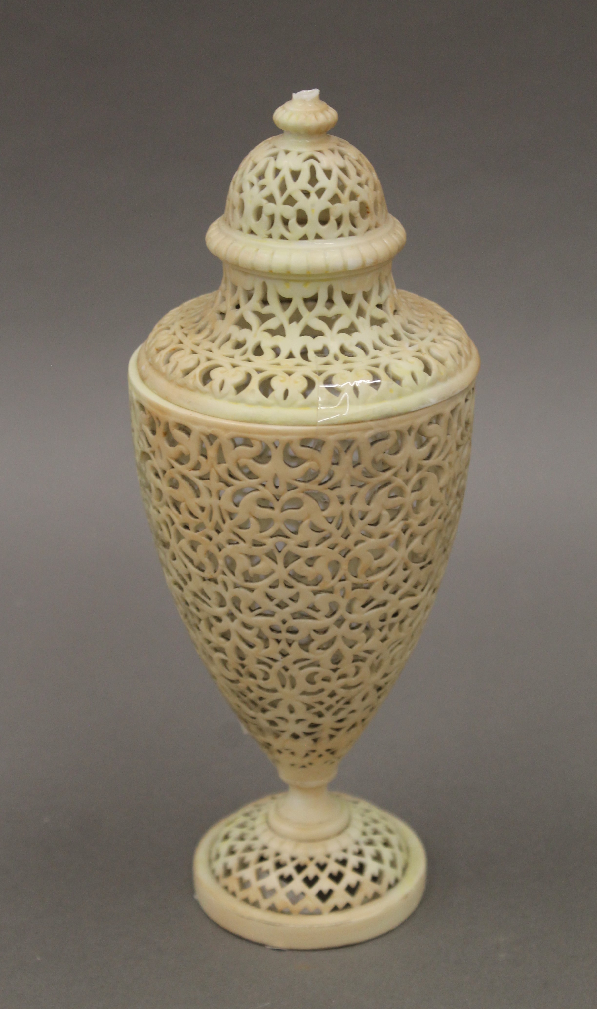 A Royal Worcester blush ivory porcelain reticulated lidded vase. 23 cm high.