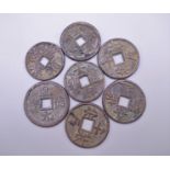 Seven Chinese coins.