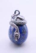 A lapis egg pendant mounted with a snake. 3 cm high.